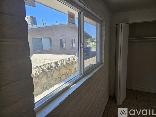 A bathroom with a window and tiled walls.