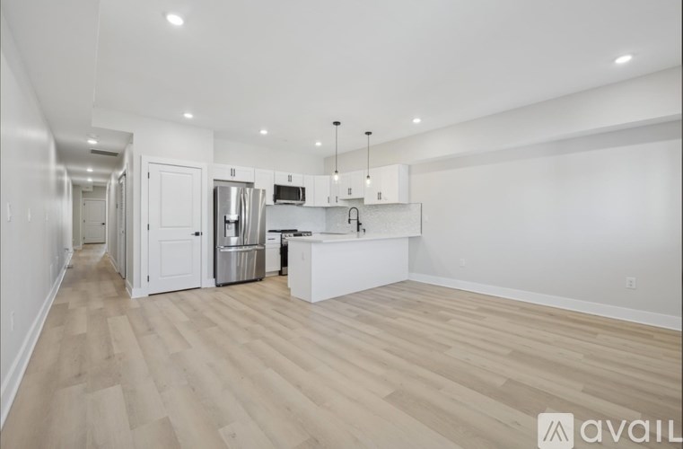 A kitchen with a refrigerator, microwave, and oven is available for rent.