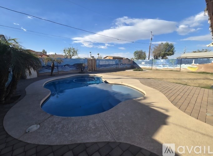 A small round pool with a concrete edge and a tiled floor.
