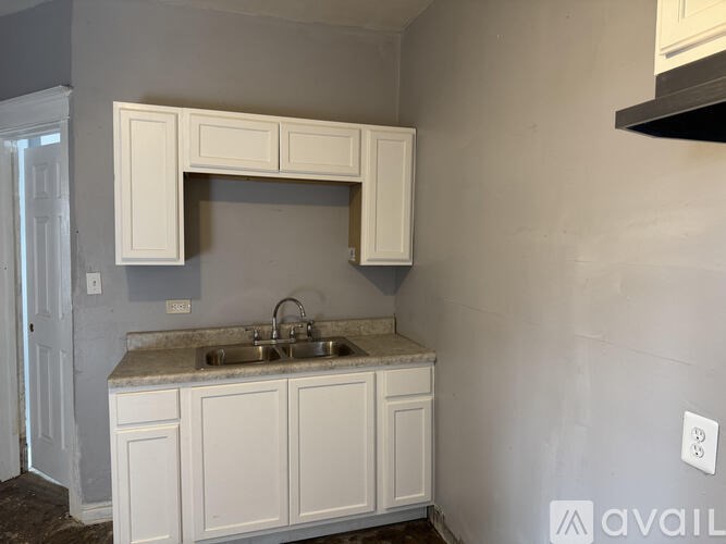 A kitchen with a sink and cabinets.