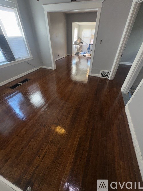 A room with wooden flooring and a staircase.