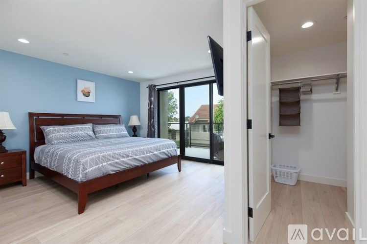 A bedroom with a bed, nightstands, and a television.