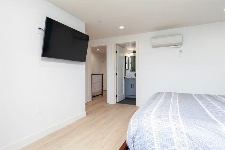 A bedroom with a bed, a television, and a closet.