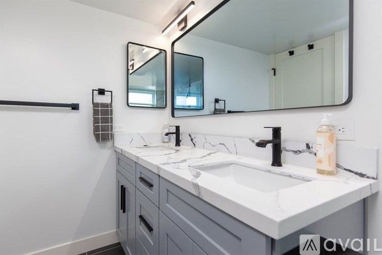 A bathroom with a white sink and a mirror above it.