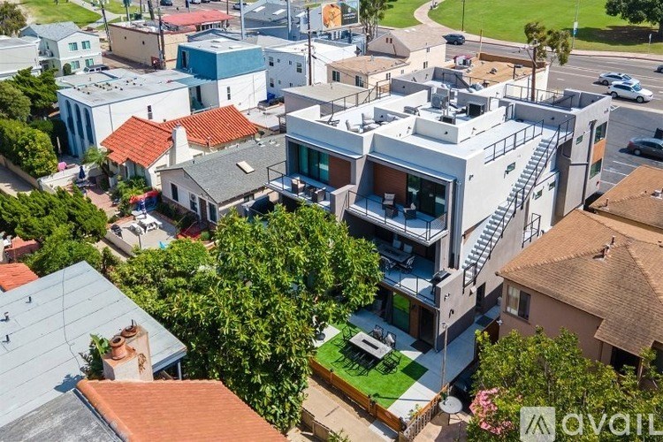 A modern house with a large front yard is for sale.