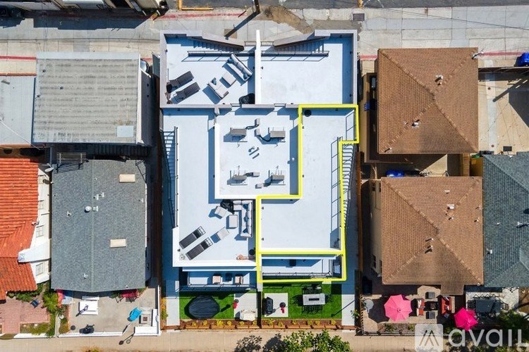 A bird is flying over a building with a blue and white exterior.