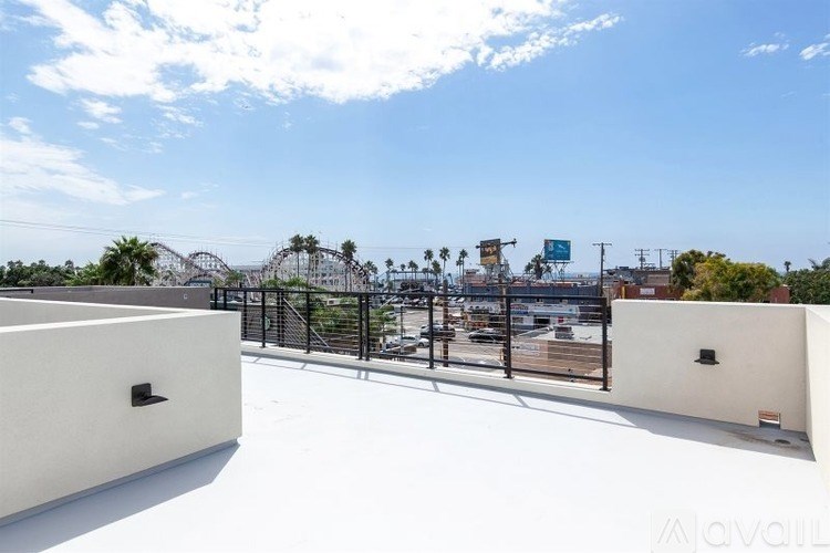 A balcony with a view of a cityscape and palm trees.