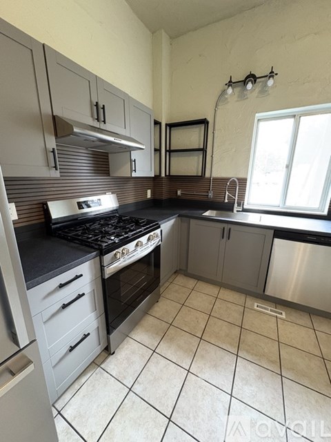 A kitchen with a stove top oven and a dishwasher.