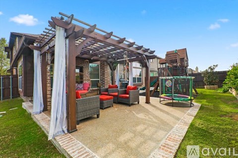 A patio area with a pergola and seating area.