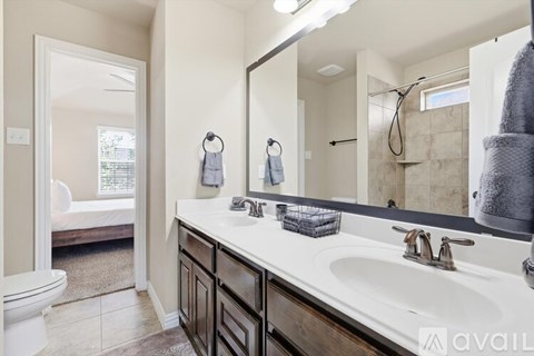 A bathroom with a white sink and a mirror.