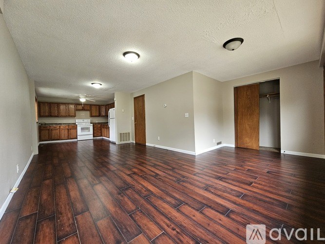 A room with wooden flooring and a ceiling light.