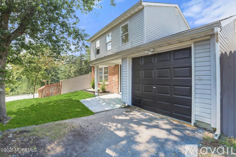 A house with a garage door is for sale.