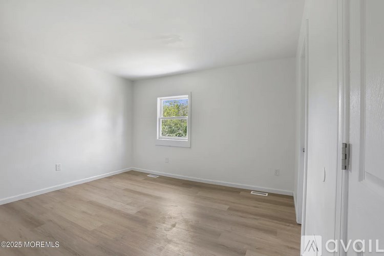 A room with a window and a door.