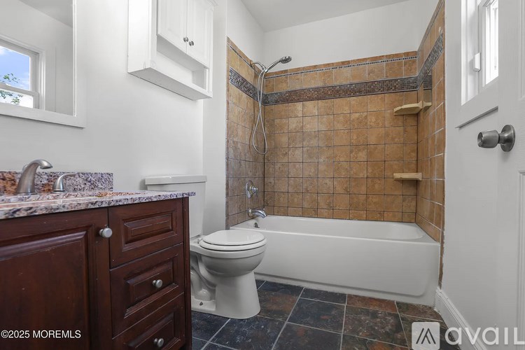 A bathroom with a toilet, tub, and sink.