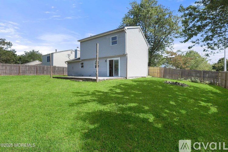 A house with a fence and a green lawn.