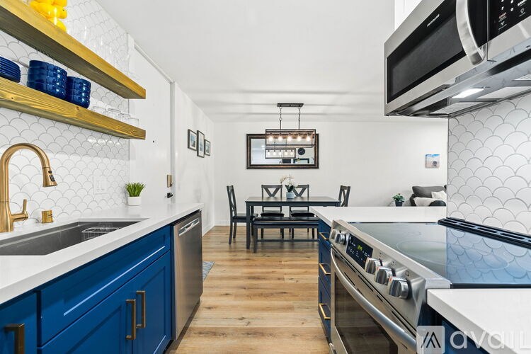 A kitchen with blue cabinets and a white countertop.