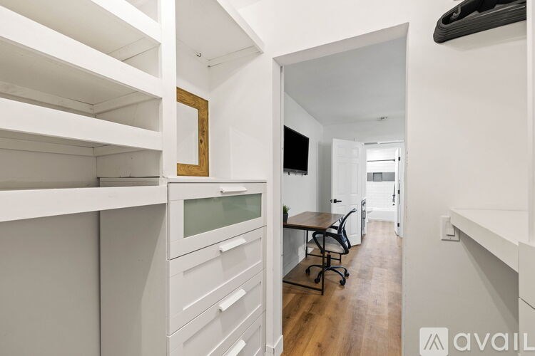 A white room with a desk and a chair.