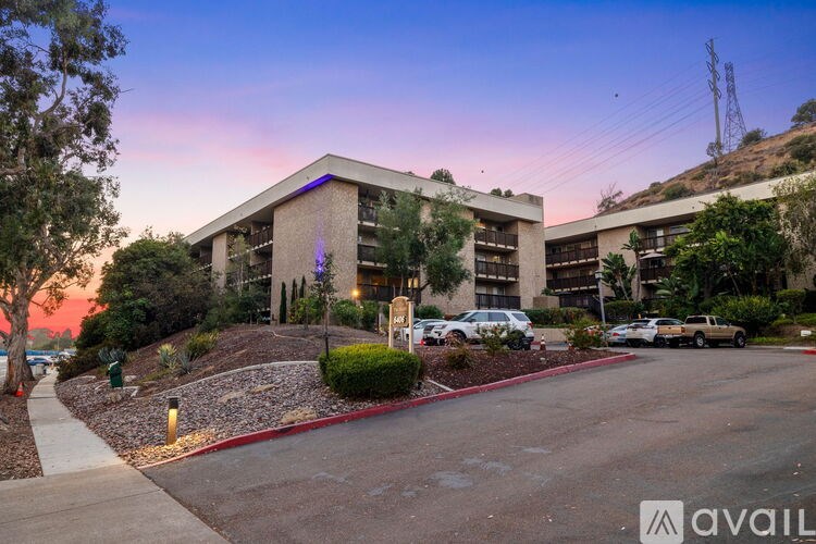 A modern building with a parking lot in front of it.