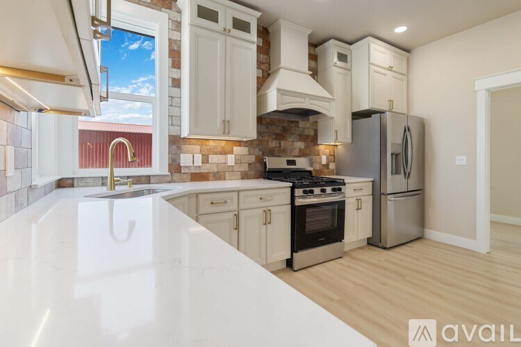 A kitchen with a white countertop and stainless steel appliances.