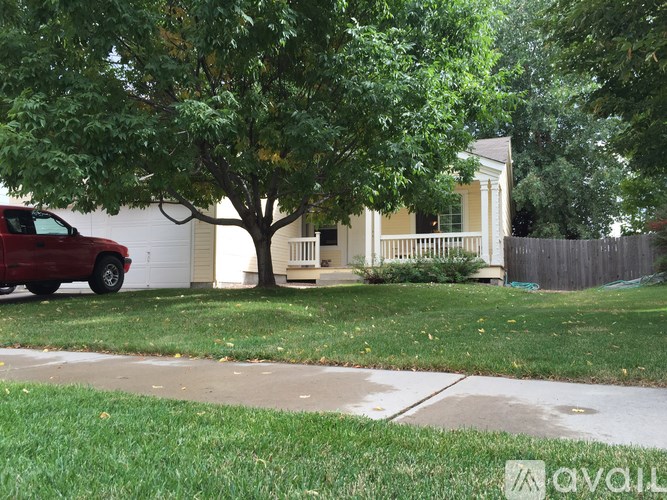A red car is parked on the side of a street.