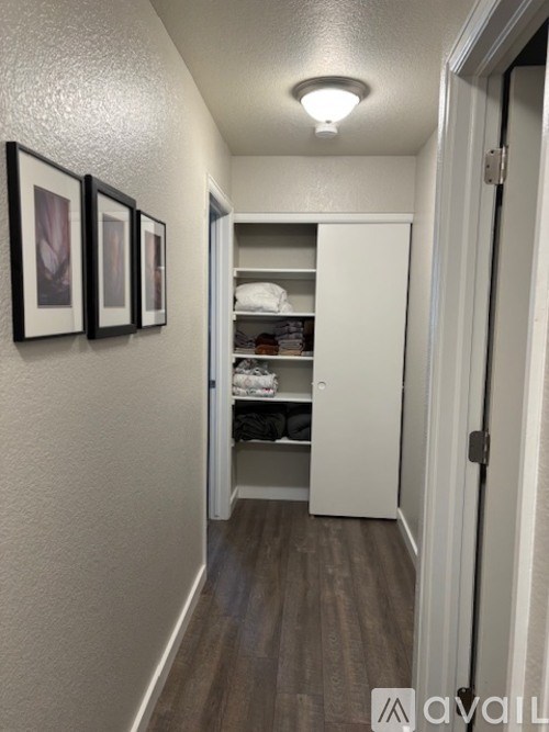 A hallway with a white door and a light on the ceiling.