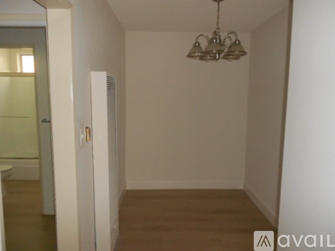 A room with a chandelier and a door.