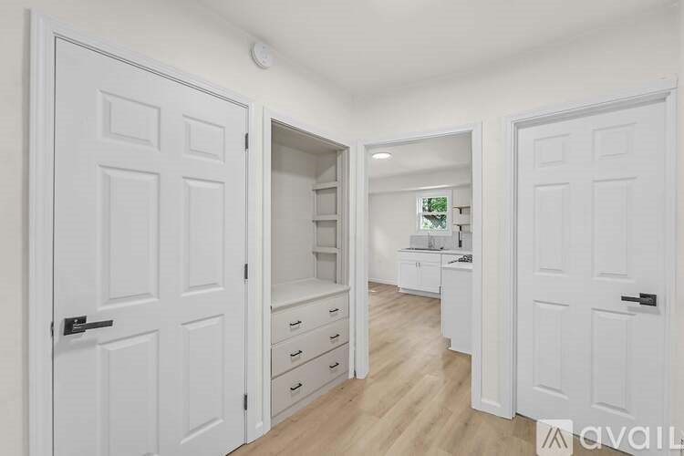 A white door with a black handle is on the left side of the image.