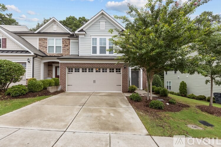 A house with a garage and a driveway in front.