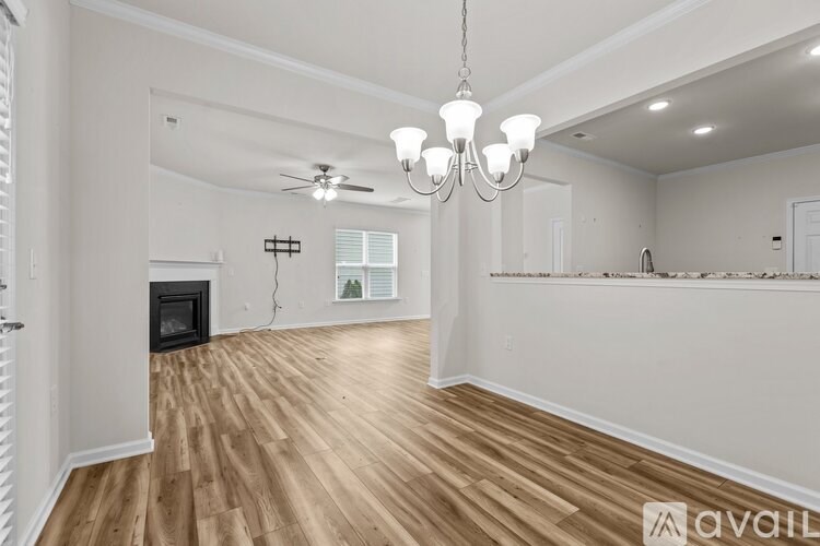 A living room with a fireplace and a chandelier.