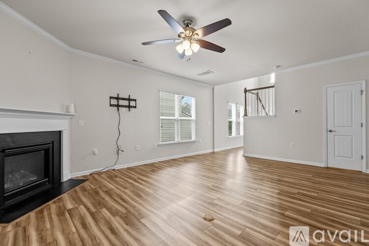 A room with a fireplace and a ceiling fan.