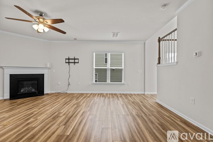 A room with a fireplace and a ceiling fan.