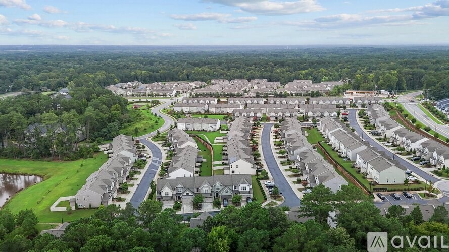 A bird's eye view of a residential area with houses and roads.