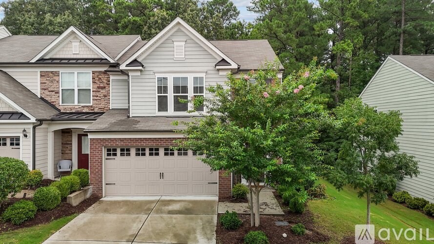A house with a garage and a driveway is for sale.