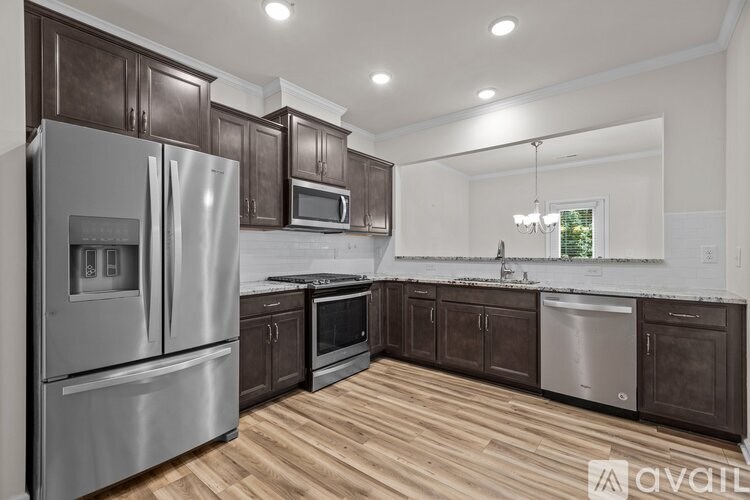 A kitchen with wooden cabinets and stainless steel appliances.