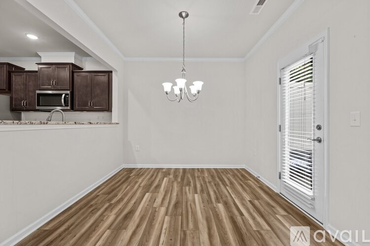 A room with wooden floors and a white door.