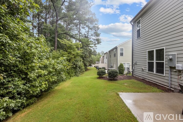 A row of houses with a grassy area in between.