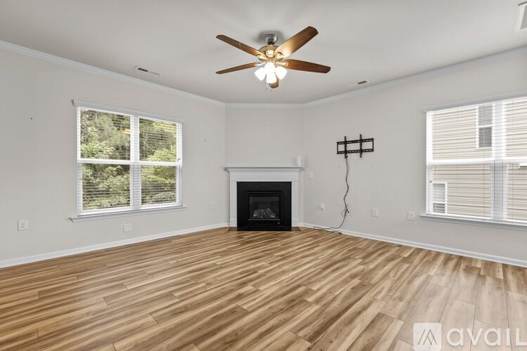 A room with a fireplace and a ceiling fan.