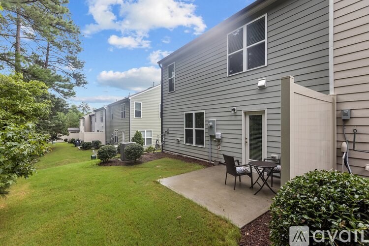 A row of houses with a lawn in front.