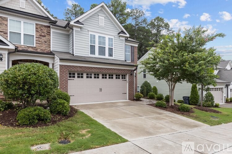 A house with a garage and a driveway is for sale.