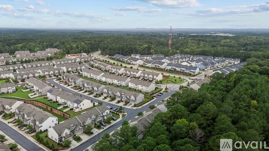 A bird's eye view of a residential area with houses and roads.