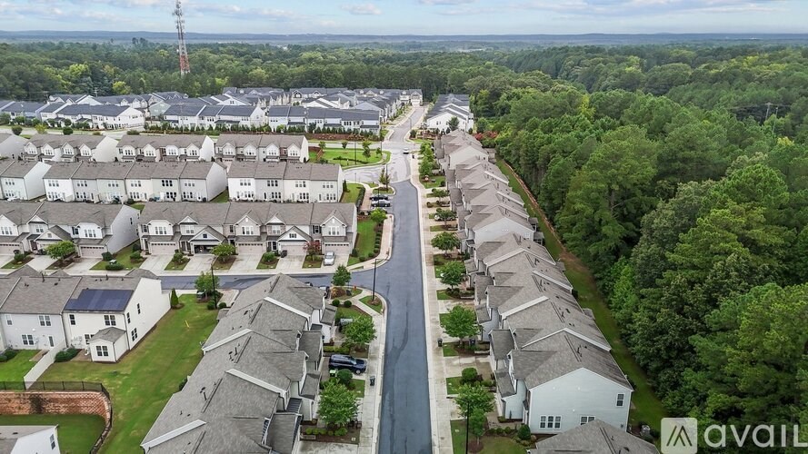 A bird's eye view of a residential area with houses and a road.
