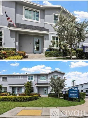 A modern two-story house with a well-maintained lawn and a flag on the front.