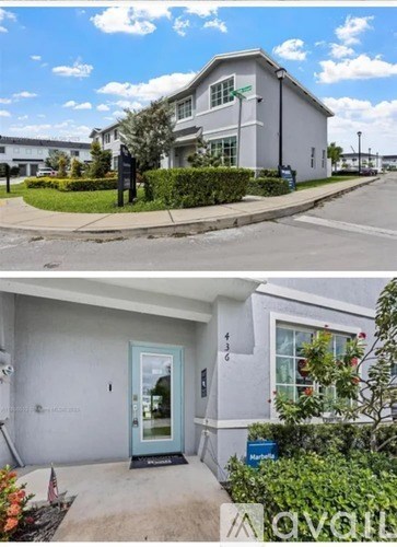 A two-story house with a blue door and a white exterior.