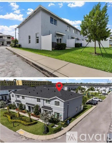 Two houses with a red location marker on the second one.