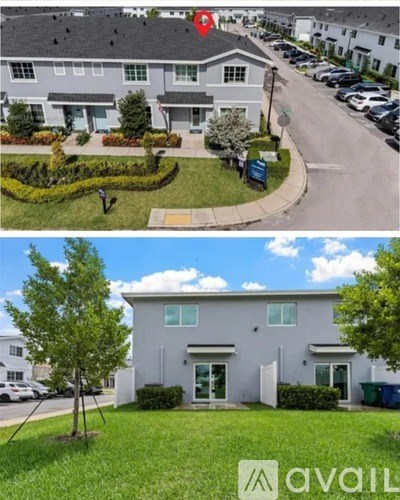A two-story house with a front yard and a driveway.
