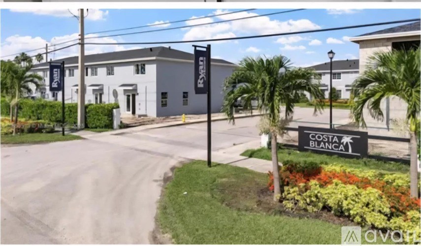 A sign for Costa Blanca is in front of a building.
