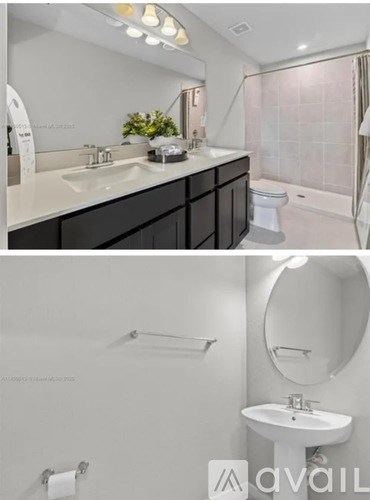 A bathroom with a white sink and a round mirror.