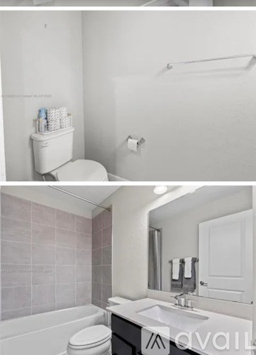 A white toilet with a white cabinet and a white sink.