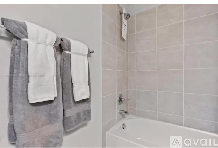 Two towels hanging on a towel rack in a bathroom.