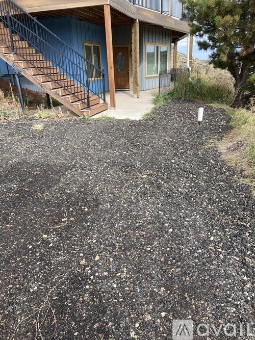 A house with a blue exterior and a brown staircase.